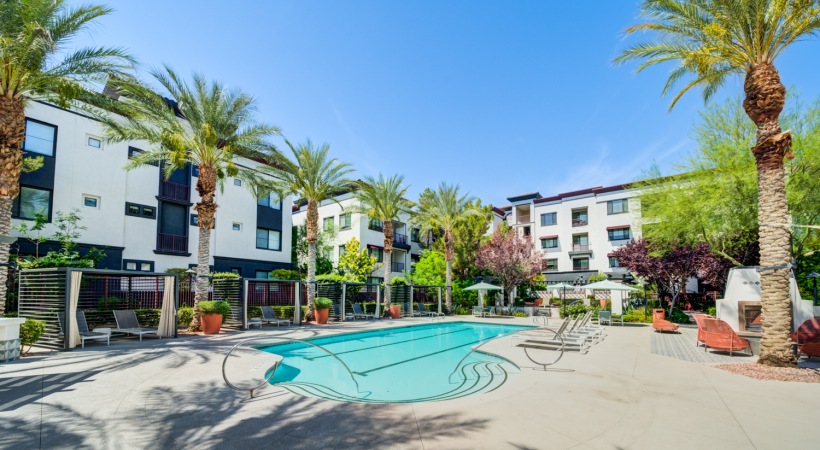 Spacious sparkling pool with sundecks and cabanas for lounging.