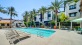 Spacious sparkling pool with sundecks and cabanas for lounging.